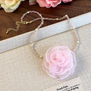 Detail of pink fabric rose choker with faceted beads and elegant gold plating clasp