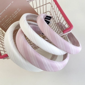 Pink and white striped cotton sponge headband with handmade label in a mini basket