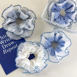 Set of four blue and white plaid scrunchies with double-layered lace and wave edges