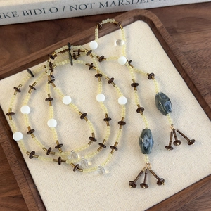 Collier artisanal de perles ethniques avec pendentif céramique et des glands