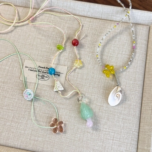 Colorful beaded necklace set with handmade flower pendants and seashell accents
