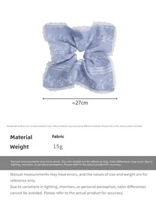 Detail view of light blue lace scrunchie with dimensions 27cm and 15g weight spec