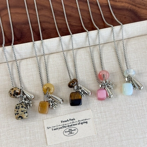 Detail view of five gemstone grape pendant necklaces in Dalmatian, yellow and pink stones