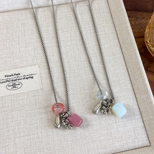 Detail of beaded grape cluster necklace with natural stone pendants and silver droplets