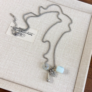 Detail of beaded grape cluster necklace with blue opal and silver water drop pendant