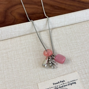 Detail of silver box chain necklace with pink stone grape cluster and water drop pendant