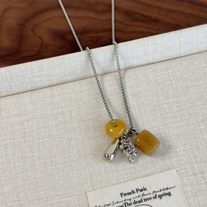 Macro detail of natural stone grape pendant necklace with adjustable silver box chain