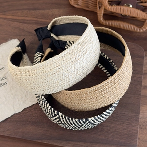 Detailed view of woven straw headbands in three colors with non-slip black inner lining