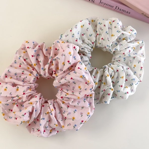 Set of floral fabric scrunchies in pink and white with a blooming wildflower pattern