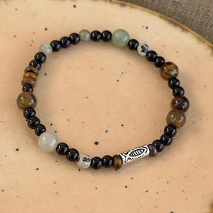 Detail view of tiger eye and onyx beaded bracelet with engraved silver fish charm
