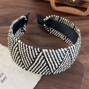 Detailed macro view of retro woven wide headband texture in black and white pattern