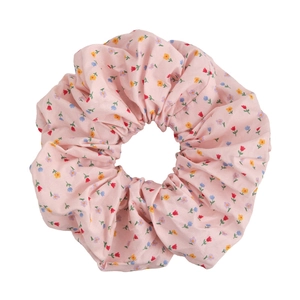 Pastel pink floral scrunchie with colorful flower patterns for elegant hairstyles