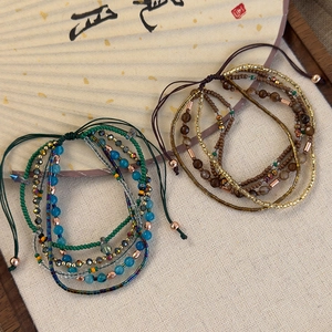 Detail view of vintage multilayer beaded bracelets in cool blue and warm brown tones