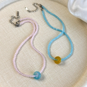 Close-up of colorful acrylic crystal beaded necklaces with lobster clasp and metal chain