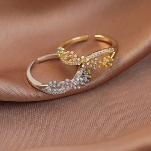 Macro view of colorful flower rings with cubic zirconia on premium brown silk background