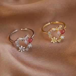 Elegant white enamel wreath open ring with zircon heart and wings on velvet background