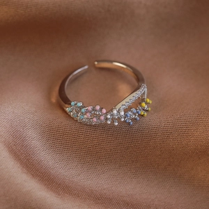 Macro detail of French style floral ring with colorful enamel beads and micro zircons
