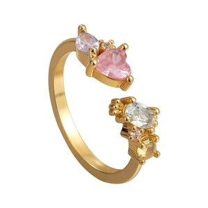 Bague ouverte dorée ajustable avec zircon cœur rose et pierres colorées sur fond blanc