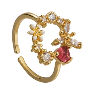 Adjustable gold ring with white enamel flowers, zircon stones and red crystal accent