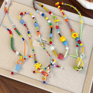 Collana di perle colorate bohémien con ciondoli a stella e fiori su vassoio per gioielli