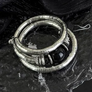 Three-layer elastic silver bracelet with black stone beads and textured metal spacers