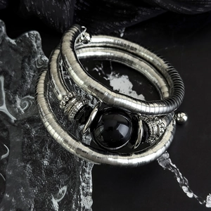 Three-layer silver spiral bracelet with central black stone and vintage metallic details