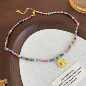 Pink stone beaded necklace with a golden sun pendant and adjustable extension chain