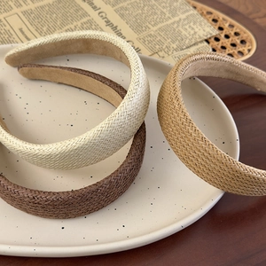 Three-piece set of woven straw headbands in beige and brown with retro vintage texture