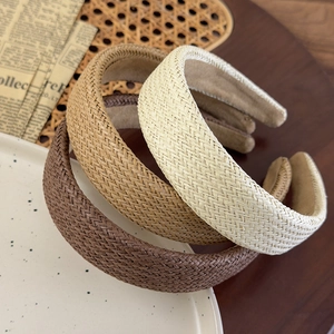 Detailed straw woven texture of wide retro headbands in brown, khaki and beige colors