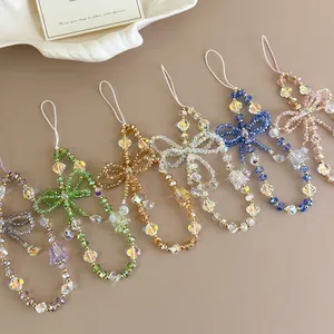 Handmade beaded phone charms with crystal beads and elegant bow tie floral design