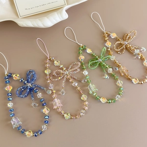 Detailed view of handmade crystal bead phone straps with bow charms in various colors