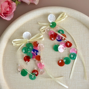 Colorful sequin drop earrings with ribbon bow and shell discs for a vacation look