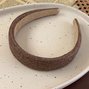 Detail of vintage dark brown woven headband featuring anti-slip inner lining texture