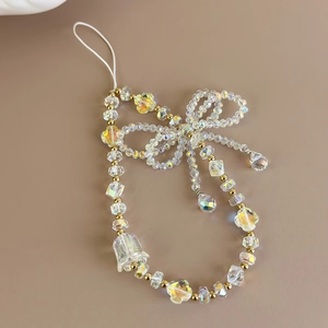 Detail of beaded phone strap with clear crystal beads, bow design and lily of the valley