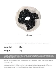 Detail showing layers of oversized white chiffon and black polka dot fabric hair scrunchie