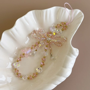 Detailed view of handmade crystal beaded phone charm with pink bow and flower detail