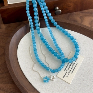 Blue cat-eye stone flower necklace set with multi-layer beads and silver pendant