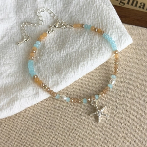 Detail of blue sea star beaded bracelet with starfish charm and adjustable silver clasp