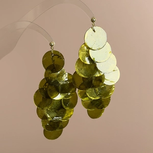 Detailed macro view of olive green layered resin disc drop earrings on a display