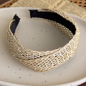 Detail of woven straw headband with cross grid texture and black anti-slip inner lining