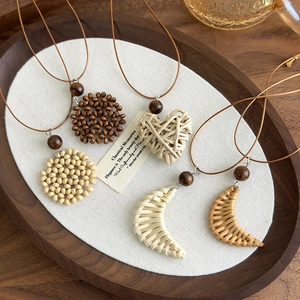 Bohemian style woven necklaces featuring heart and moon pendants in vintage wood finish
