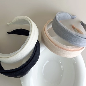 Detail view of sheer pleated wide headbands in white, black, beige, and blue fabric
