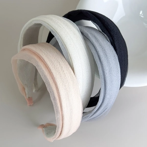 Close-up of four colored gauze wide headbands showing textured fabric and thick sponge padding