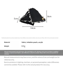 Detail view of large French hair clip with dense white pearls and black fabric base