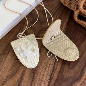 Détail de pendentifs étoile de mer tressés avec perles sur bois foncé
