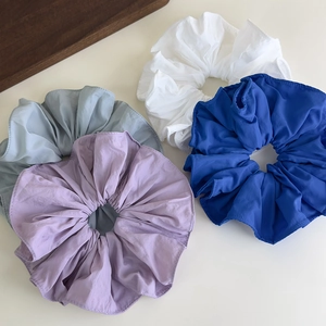 Set of four oversized solid color scrunchies in white, blue, green, and lilac fabric