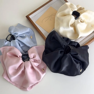 Detail view of large satin fabric claw clips in beige, blue, pink and black set