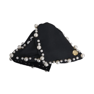 Elegant black fabric hair claw with white pearls and a gold metal logo detail