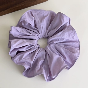 Detail view of large lilac purple scrunchie with soft ruffled texture and neat stitching