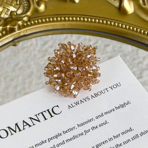 Detailed macro view of champagne gold handcrafted crystal bead charms for clogs and DIY shoes